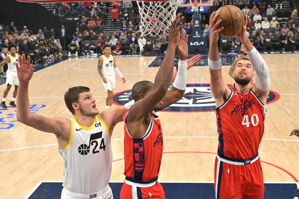 Dec 16, 2024; Inglewood, California, USA;  Los Angeles Clippers center Ivica Zubac (40) reaches in front of Utah Jazz center Walker Kessler (24) and Los Angeles Clippers forward Kai Jones (23) in the first half at Intuit Dome. Mandatory Credit: Jayne Kamin-Oncea-Imagn Images