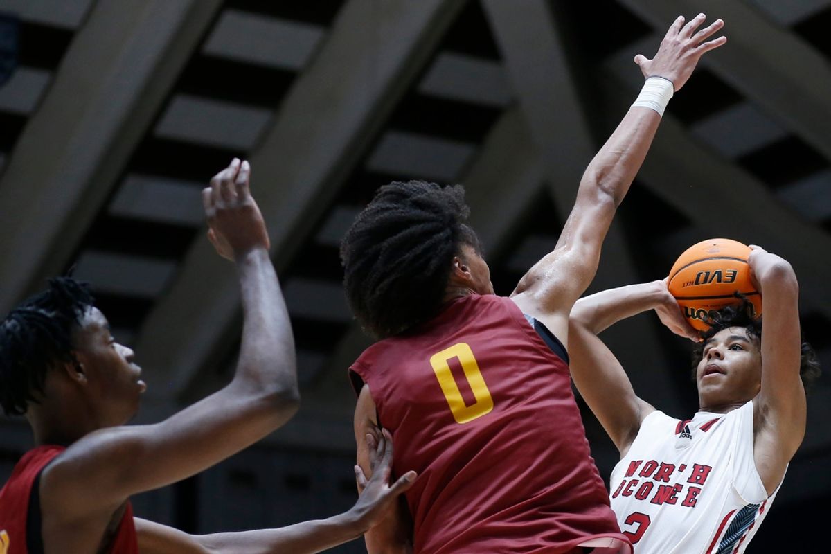 North Oconee's Justin Wise (2) takes a shot while being defended by Holy Innocents Episcopal's Will Hopkins (0) and Holy Innocents Episcopal's Caleb Wilson (24) during the GHSA high school basketball AAAA Region 8 championship game in Macon, Ga., on Wednesday, March 6, 2024. North Oconee won 65-60.
