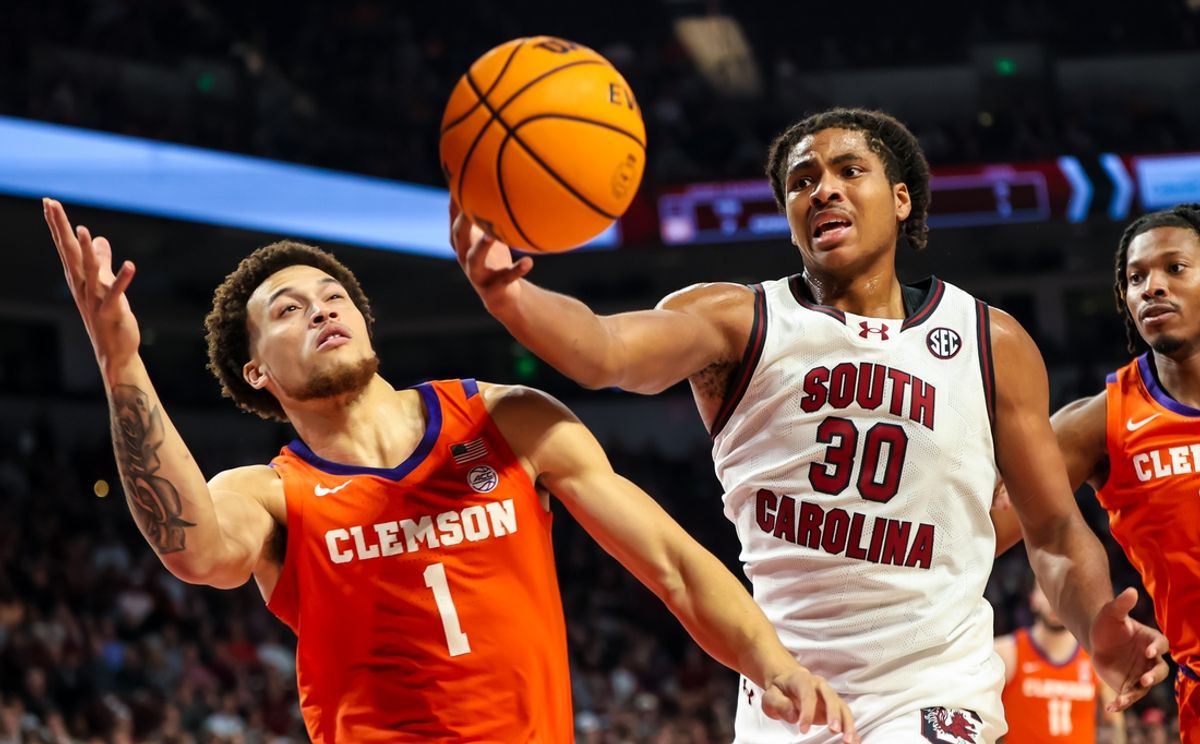 Dec 17, 2024; Columbia, South Carolina, USA; South Carolina Gamecocks forward Collin Murray-Boyles (30) grabs a rebound in front of Clemson Tigers guard Chase Hunter (1) in the first half at Colonial Life Arena. Mandatory Credit: Jeff Blake-Imagn Images