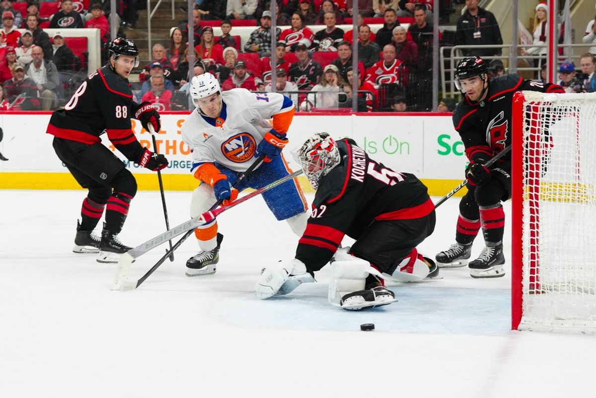 Dec 17, 2024; Raleigh, North Carolina, USA;  New York Islanders center Mathew Barzal (13) shoots against Carolina Hurricanes goaltender Pyotr Kochetkov (52) during the second period at Lenovo Center. Mandatory Credit: James Guillory-Imagn Images