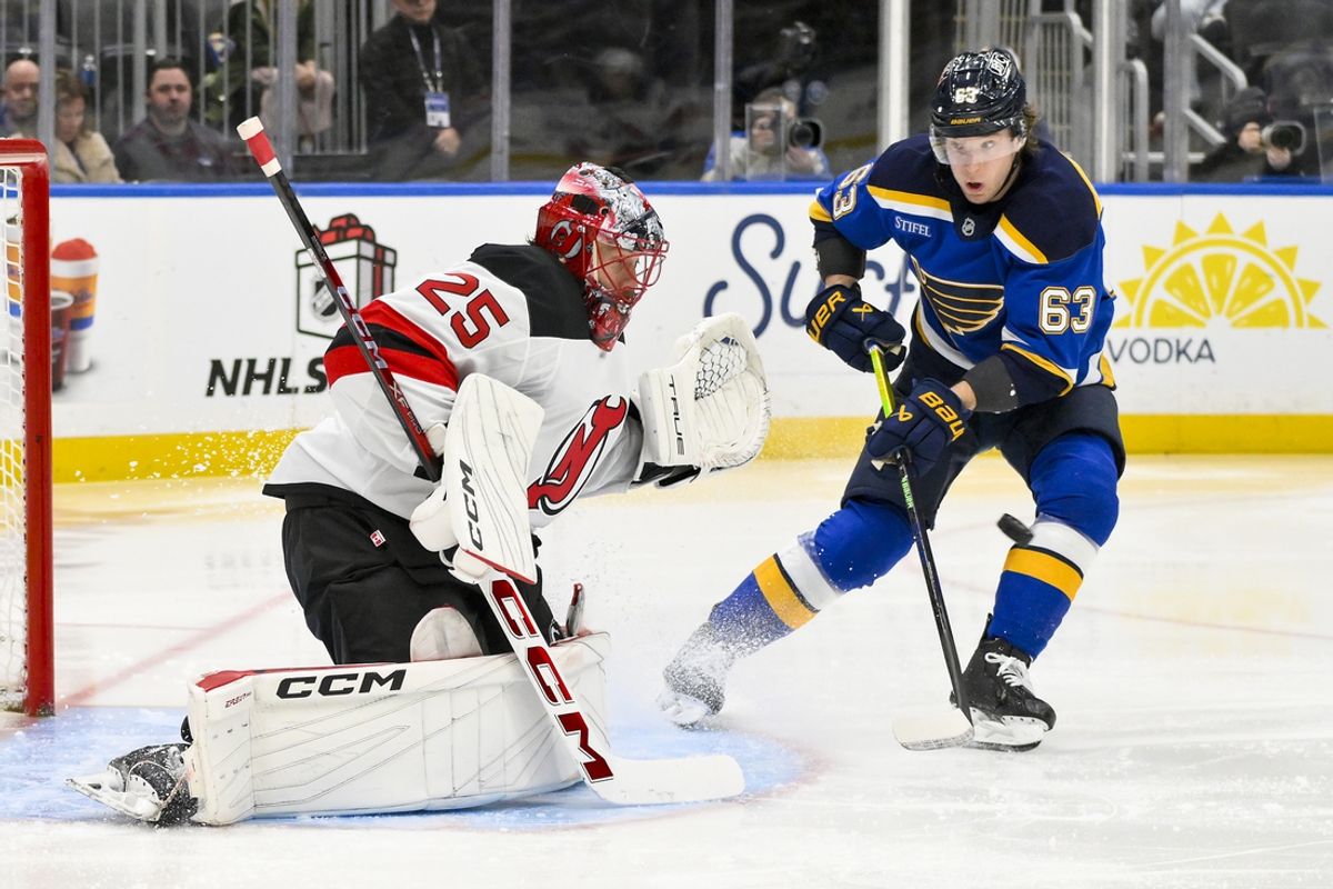 Dec 17, 2024; St. Louis, Missouri, USA;  New Jersey Devils goaltender Jacob Markstrom (25) defends the net against St. Louis Blues left wing Jake Neighbours (63) during the second period at Enterprise Center. Mandatory Credit: Jeff Curry-Imagn Images