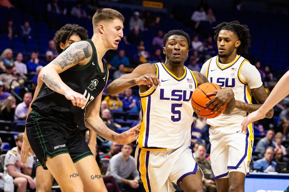 Dec 17, 2024; Baton Rouge, Louisiana, USA;  LSU Tigers guard Cam Carter (5) dribbles against Stetson Hatters forward Treyton Thompson (42) during the first half at Pete Maravich Assembly Center. Mandatory Credit: Stephen Lew-Imagn Images