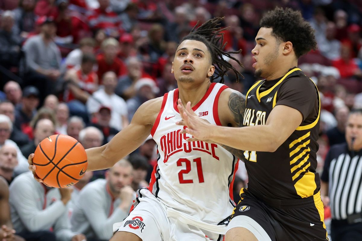 Dec 17, 2024; Columbus, Ohio, USA;  Ohio State Buckeyes forward Devin Royal (21) dribbles past Valparaiso Beacons forward Devon Ellis (11) during the second half at Value City Arena. Mandatory Credit: Joseph Maiorana-Imagn Images