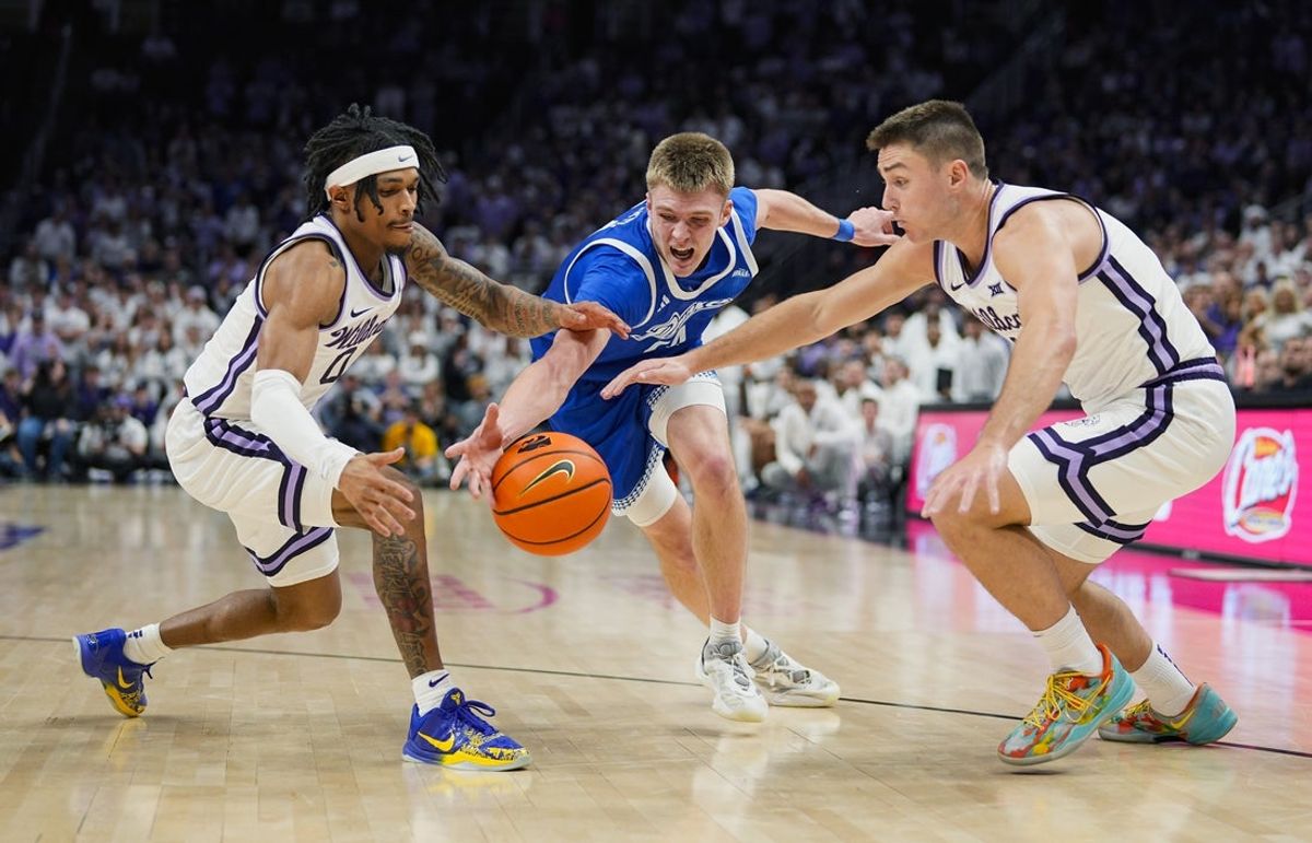 Dec 17, 2024; Kansas City, Missouri, USA; Drake Bulldogs guard Bennett Stirtz (14) fights for a loose ball against Kansas State Wildcats guard Dug McDaniel (0) and guard Brendan Hausen (11) during the second half at T-Mobile Center. Mandatory Credit: Jay Biggerstaff-Imagn Images