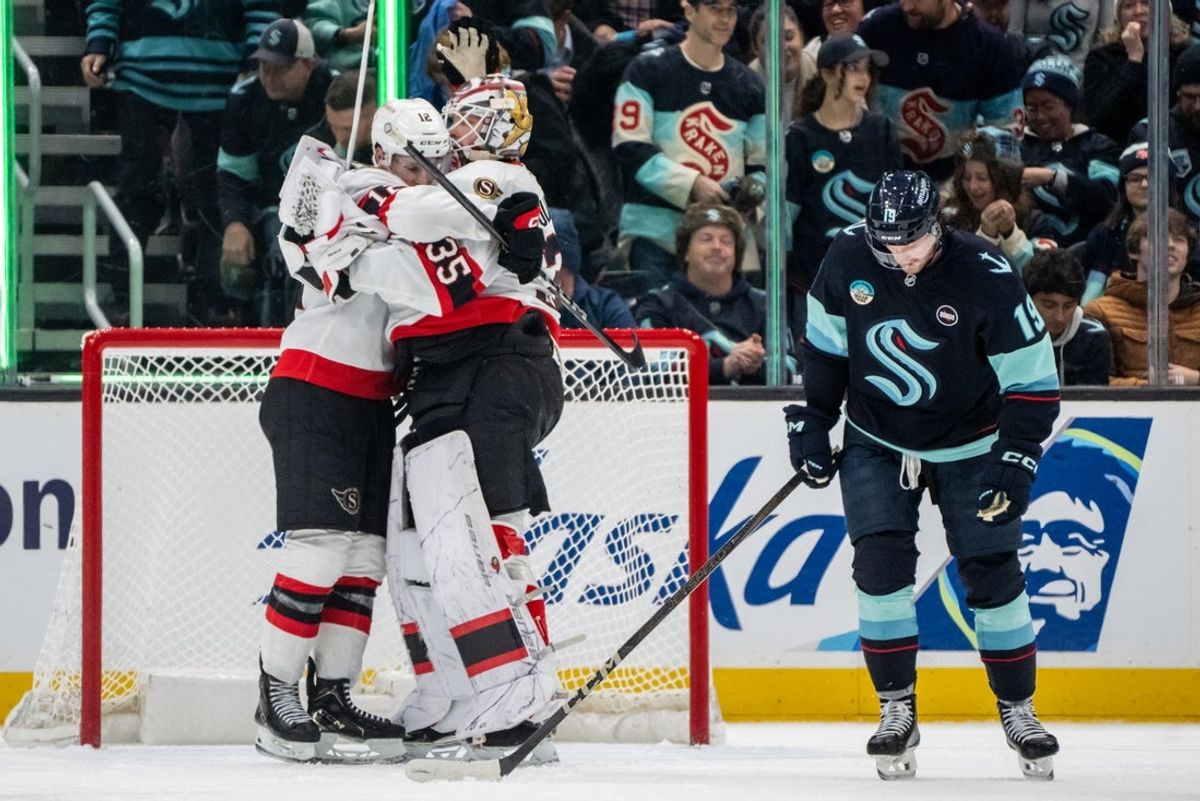 Dec 17, 2024; Seattle, Washington, USA;  Ottawa Senators goalie Linus Ullmark (35) and forward Shane Pinto (12) celebrate after a game against Seattle Kraken at Climate Pledge Arena. At right is Seattle Kraken forward Jared McCann (19) Mandatory Credit: Stephen Brashear-Imagn Images