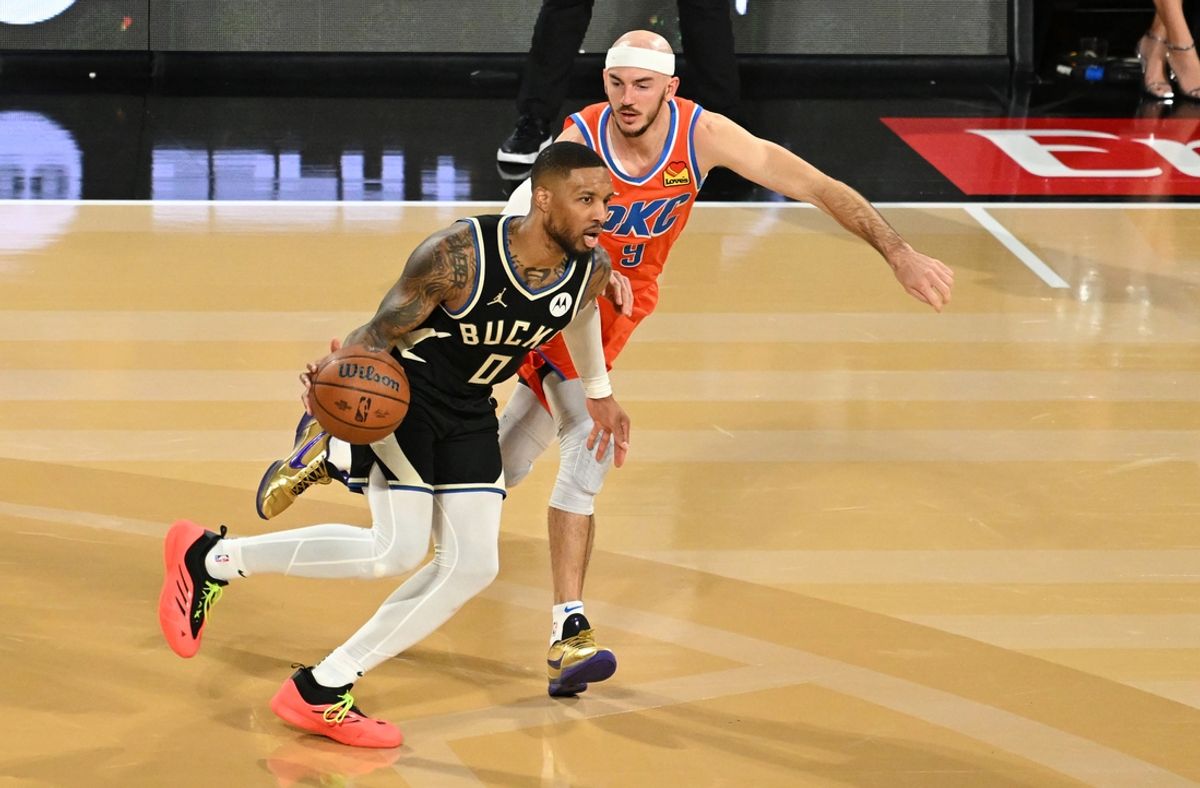Dec 17, 2024; Las Vegas, Nevada, USA; Milwaukee Bucks guard Damian Lillard (0) dribbles against Oklahoma City Thunder guard Alex Caruso (9) during the 4th quarter in the Emirates NBA Cup championship game at T-Mobile Arena. Mandatory Credit: Candice Ward-Imagn Images
