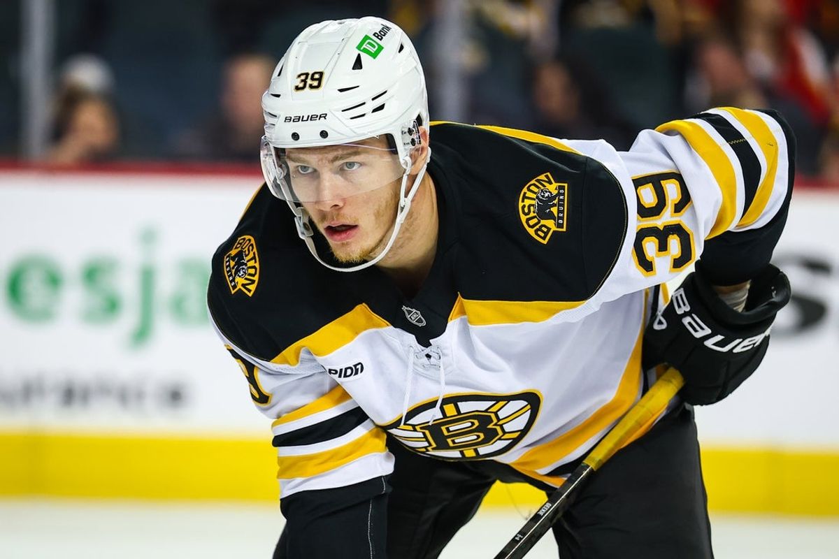 Dec 17, 2024; Calgary, Alberta, CAN; Boston Bruins center Morgan Geekie (39) during the face off against the Calgary Flames during the third period at Scotiabank Saddledome. Mandatory Credit: Sergei Belski-Imagn Images