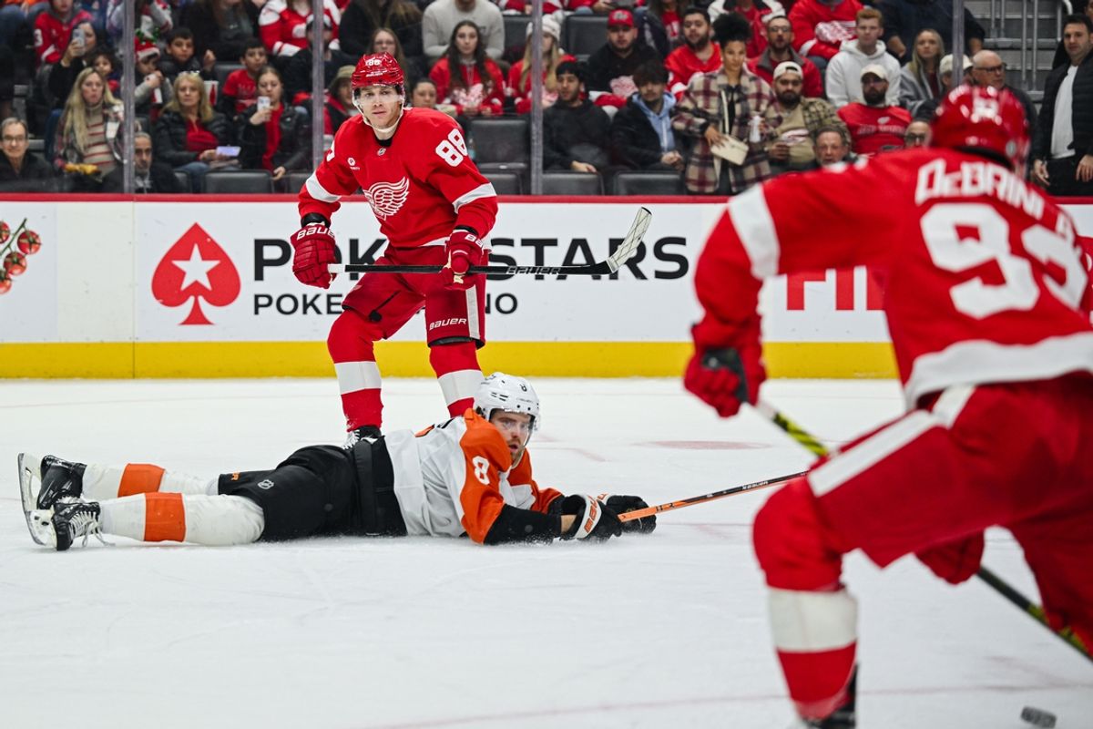 Dec 18, 2024; Detroit, Michigan, USA; Detroit Red Wings right wing Patrick Kane (88) makes an assist to right wing Alex DeBrincat (93) as Philadelphia Flyers defenseman Cam York (8) attempts to defend during the second period at Little Caesars Arena. Mandatory Credit: Tim Fuller-Imagn Images