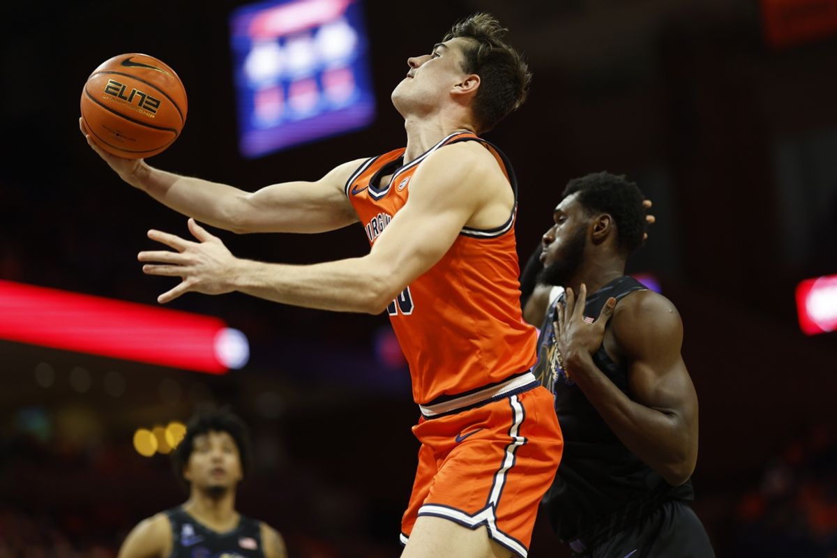 Dec 18, 2024; Charlottesville, Virginia, USA; Virginia Cavaliers guard Taine Murray (10) shoots the ball as Memphis Tigers center Moussa Cisse (32) defends in the second half at John Paul Jones Arena. Mandatory Credit: Geoff Burke-Imagn Images