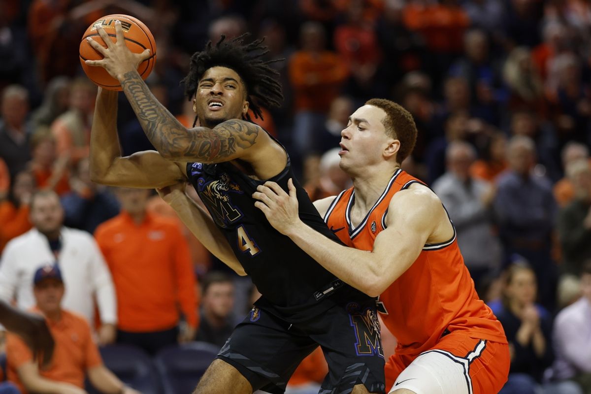 Dec 18, 2024; Charlottesville, Virginia, USA; Memphis Tigers guard PJ Haggerty (4) holds the ball as Virginia Cavaliers forward Elijah Saunders (2) defends in the second half at John Paul Jones Arena. Mandatory Credit: Geoff Burke-Imagn Images