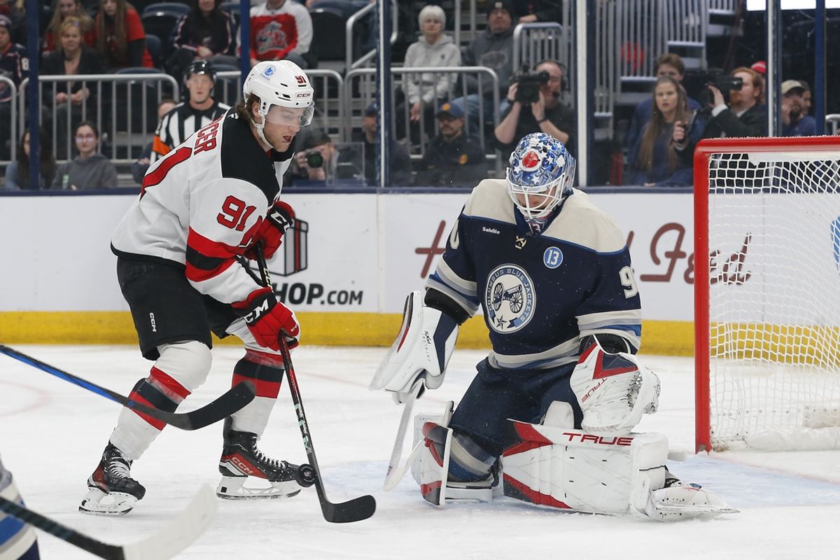 Dec 19, 2024; Columbus, Ohio, USA; New Jersey Devils center Dawson Mercer (91) looks for a rebound of a Columbus Blue Jackets goalie Elvis Merzlikins (90) pad save during the first period at Nationwide Arena. Mandatory Credit: Russell LaBounty-Imagn Images