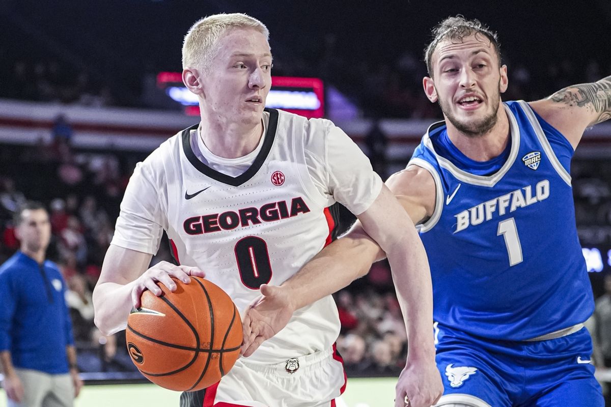 Dec 19, 2024; Athens, Georgia, USA; Georgia Bulldogs guard Blue Cain (0) dribbles defended by Buffalo Bulls forward Noah Batchelor (1) during the first half at Stegeman Coliseum. Mandatory Credit: Dale Zanine-Imagn Images