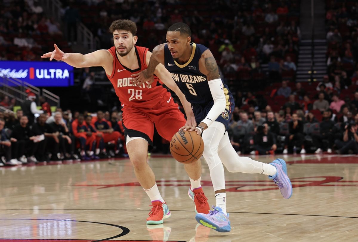 Dec 19, 2024; Houston, Texas, USA;  New Orleans Pelicans guard Dejounte Murray (5) dribbles past Houston Rockets center Alperen Sengun (28) in the first quarter at Toyota Center. Mandatory Credit: Thomas Shea-Imagn Images