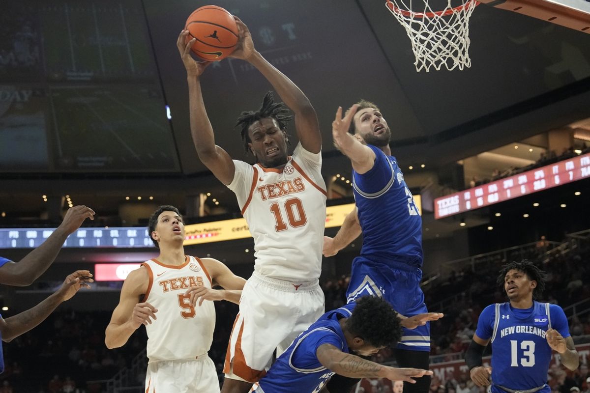 Dec 19, 2024; Austin, Texas, USA; Texas Longhorns forward Nic Codie (10) grabs a rebound over New Orleans forward Luke Davis (20) during the first half at Moody Center. Mandatory Credit: Scott Wachter-Imagn Images