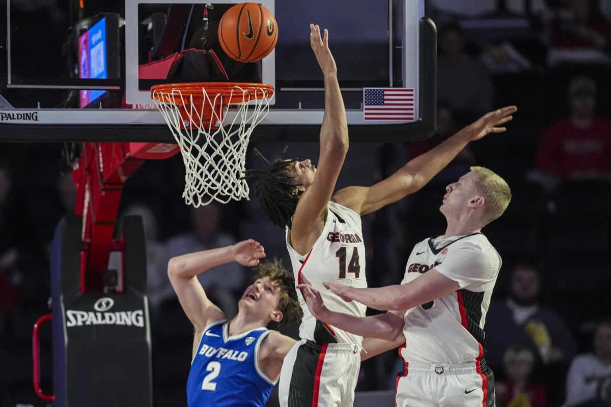 Dec 19, 2024; Athens, Georgia, USA; Georgia Bulldogs forward Asa Newell (14) defends against Buffalo Bulls guard Ryan Sabol (2) at Stegeman Coliseum. Mandatory Credit: Dale Zanine-Imagn Images