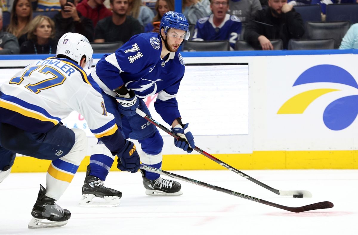 Dec 19, 2024; Tampa, Florida, USA; Tampa Bay Lightning center Anthony Cirelli (71) passes the puck as St. Louis Blues defenseman Cam Fowler (17) defends during the third period at Amalie Arena. Mandatory Credit: Kim Klement Neitzel-Imagn Images