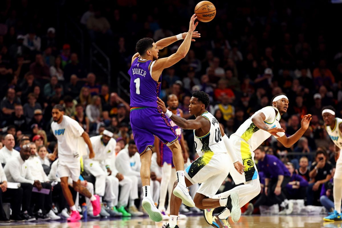 Dec 19, 2024; Phoenix, Arizona, USA; Phoenix Suns guard Devin Booker (1) passes the ball against Indiana Pacers guard Bennedict Mathurin (00) during the first quarter at Footprint Center. Mandatory Credit: Mark J. Rebilas-Imagn Images