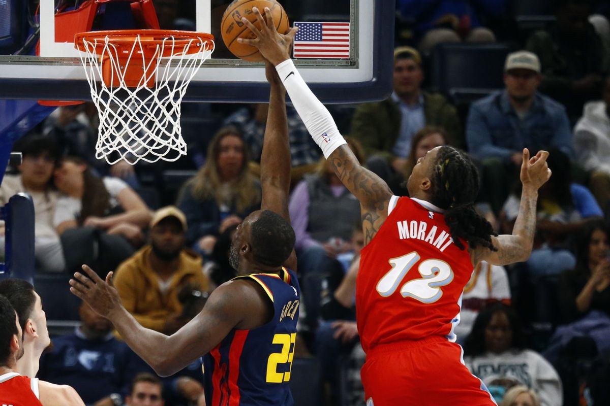 Dec 19, 2024; Memphis, Tennessee, USA; Memphis Grizzlies guard Ja Morant (12) blocks the shot attempt by Golden State Warriors forward Draymond Green (23) during the second quarter at FedExForum. Mandatory Credit: Petre Thomas-Imagn Images