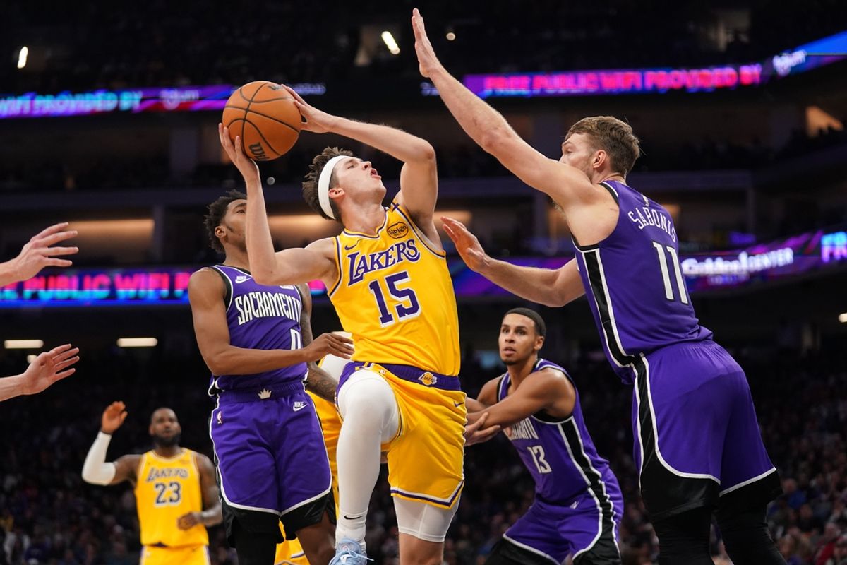 Dec 19, 2024; Sacramento, California, USA; Los Angeles Lakers guard Austin Reaves (15) shoots the ball next to Sacramento Kings center Domantas Sabonis (11) in the second quarter at the Golden 1 Center. Mandatory Credit: Cary Edmondson-Imagn Images