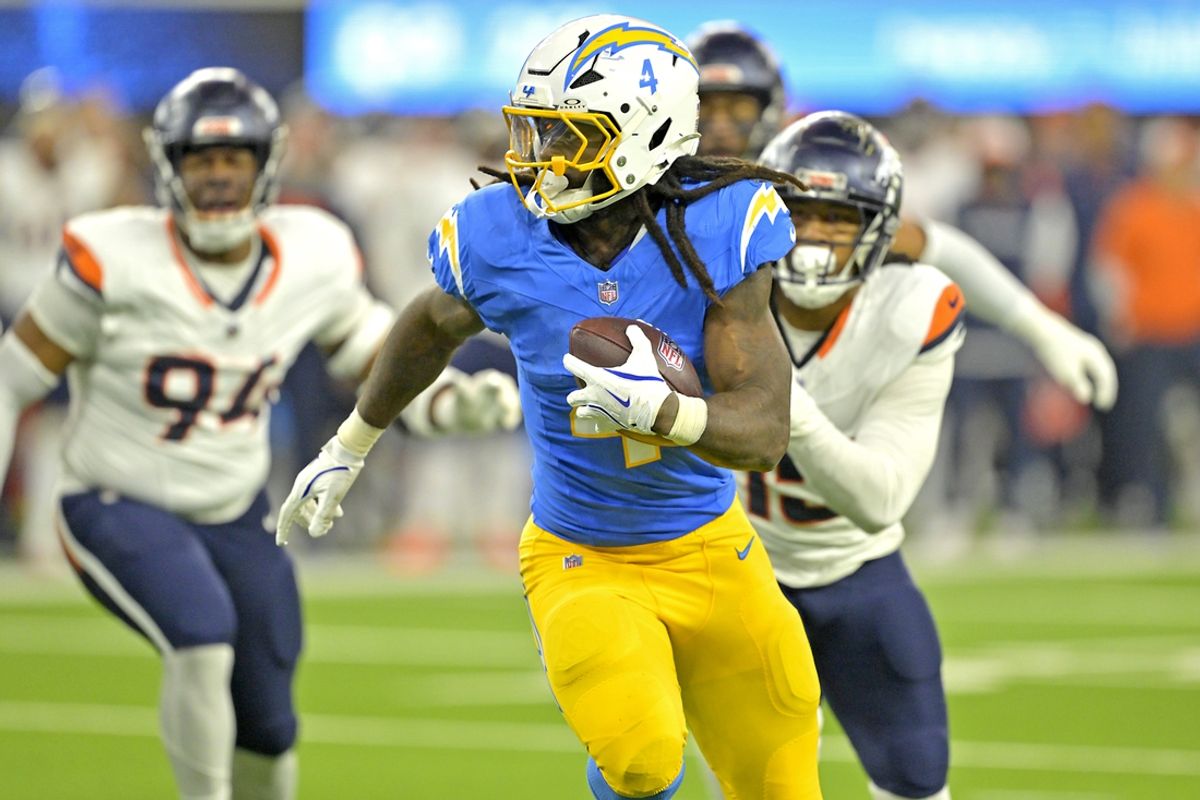 Dec 19, 2024; Inglewood, California, USA;  Los Angeles Chargers running back Gus Edwards (4) runs for a touchdown in the second half against the Denver Broncos at SoFi Stadium. Mandatory Credit: Jayne Kamin-Oncea-Imagn Images