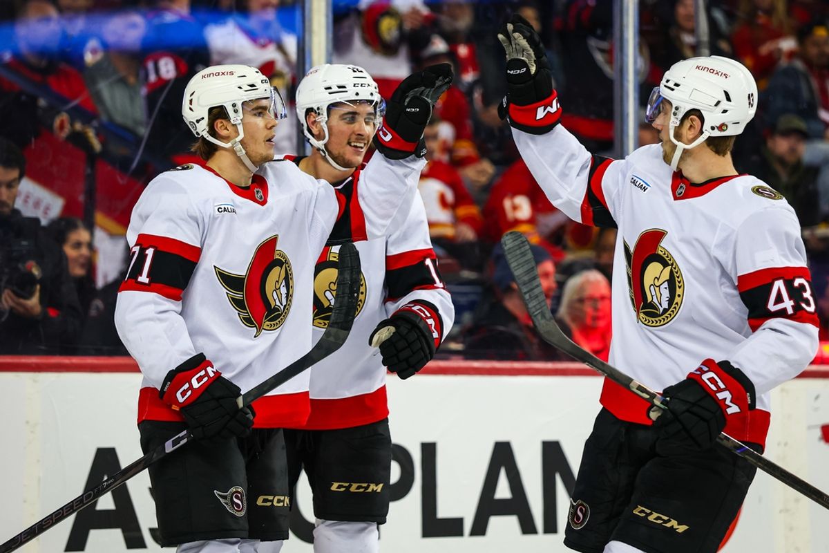 Dec 19, 2024; Calgary, Alberta, CAN; Ottawa Senators center Ridly Greig (71) celebrates his goal with teammates against the Calgary Flames during the third period at Scotiabank Saddledome. Mandatory Credit: Sergei Belski-Imagn Images