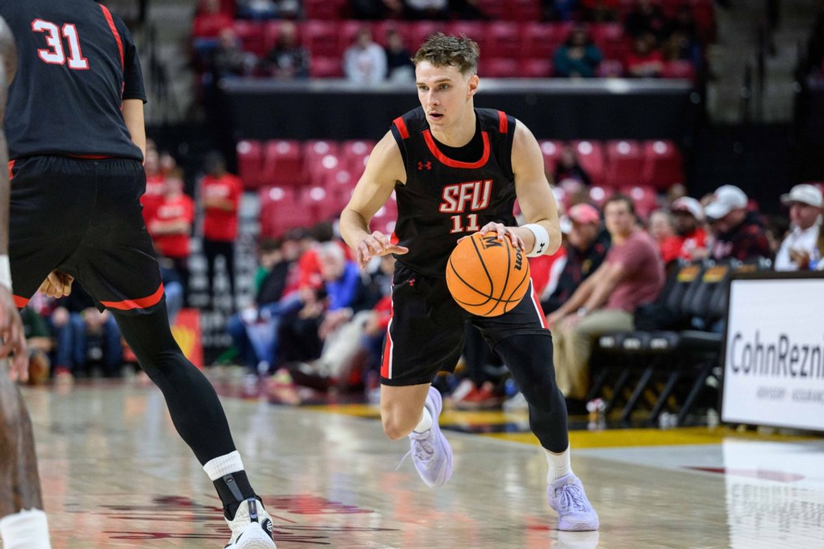 Dec 17, 2024; College Park, Maryland, USA; St. Francis (Pa) Red Flash guard Riley Parker (11) drives to the basket against the Maryland Terrapins during the first half at Xfinity Center. Mandatory Credit: Reggie Hildred-Imagn Images