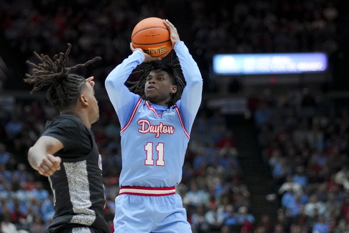 Dec 20, 2024; Cincinnati, Ohio, USA;  Dayton Flyers guard Malachi Smith (11) shoots against Cincinnati Bearcats guard Jizzle James (2) in the first half at Heritage Bank Center. Mandatory Credit: Aaron Doster-Imagn Images