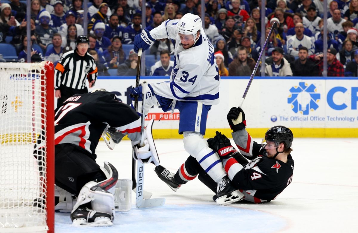 Dec 20, 2024; Buffalo, New York, USA;  Buffalo Sabres goaltender James Reimer (47) makes a save on Toronto Maple Leafs center Auston Matthews (34) as Buffalo Sabres defenseman Bowen Byram (4) falls down trying to defend during the third period at KeyBank Center. Mandatory Credit: Timothy T. Ludwig-Imagn Images