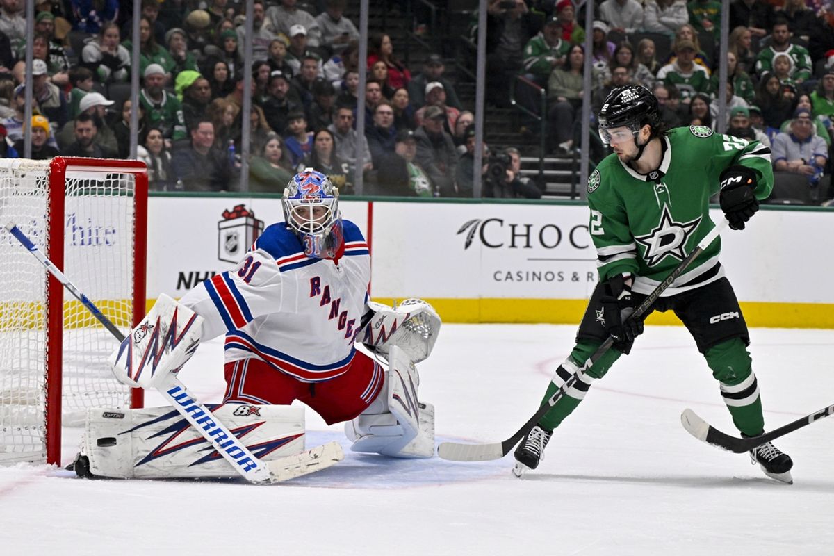 Dec 20, 2024; Dallas, Texas, USA; Dallas Stars center Mavrik Bourque (22) attempts to redirect the puck past New York Rangers goaltender Igor Shesterkin (31) during the second period at the American Airlines Center. Mandatory Credit: Jerome Miron-Imagn Images