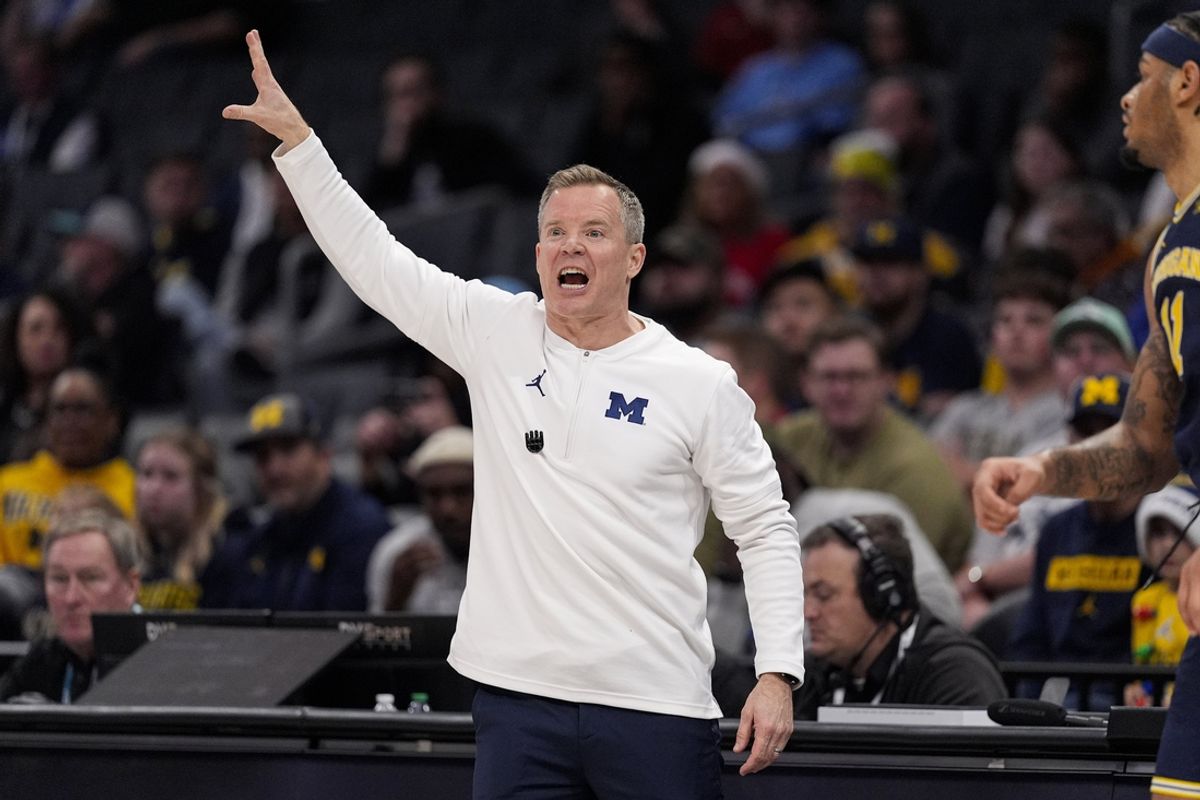 Dec 18, 2024; Charlotte, North Carolina, USA; Michigan Wolverines head coach Dusty May yells to his team during the first half against the Oklahoma Sooners at Spectrum Center. Mandatory Credit: Jim Dedmon-Imagn Images