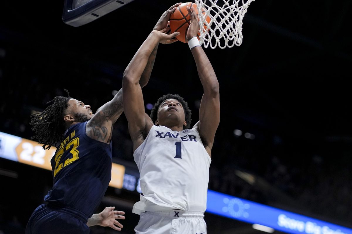 Dec 21, 2024; Cincinnati, Ohio, USA;  Marquette Golden Eagles forward David Joplin (23) blocks a dunk attempt by Xavier Musketeers guard Marcus Foster (1) in the first half at Cintas Center. Mandatory Credit: Aaron Doster-Imagn Images