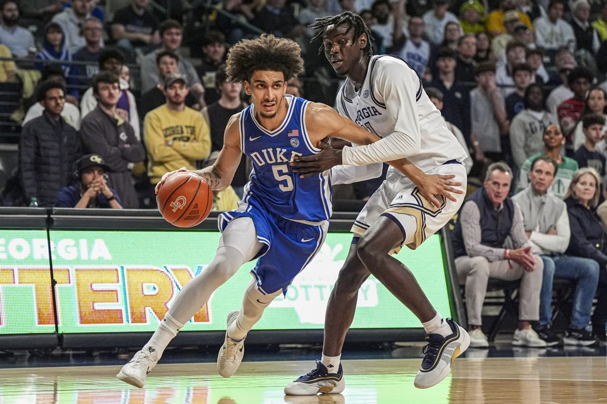 Dec 21, 2024; Atlanta, Georgia, USA; Duke Blue Devils guard Tyrese Proctor (5) is defended by Georgia Tech Yellow Jackets forward Baye Ndongo (11) during the first half at McCamish Pavilion. Mandatory Credit: Dale Zanine-Imagn Images