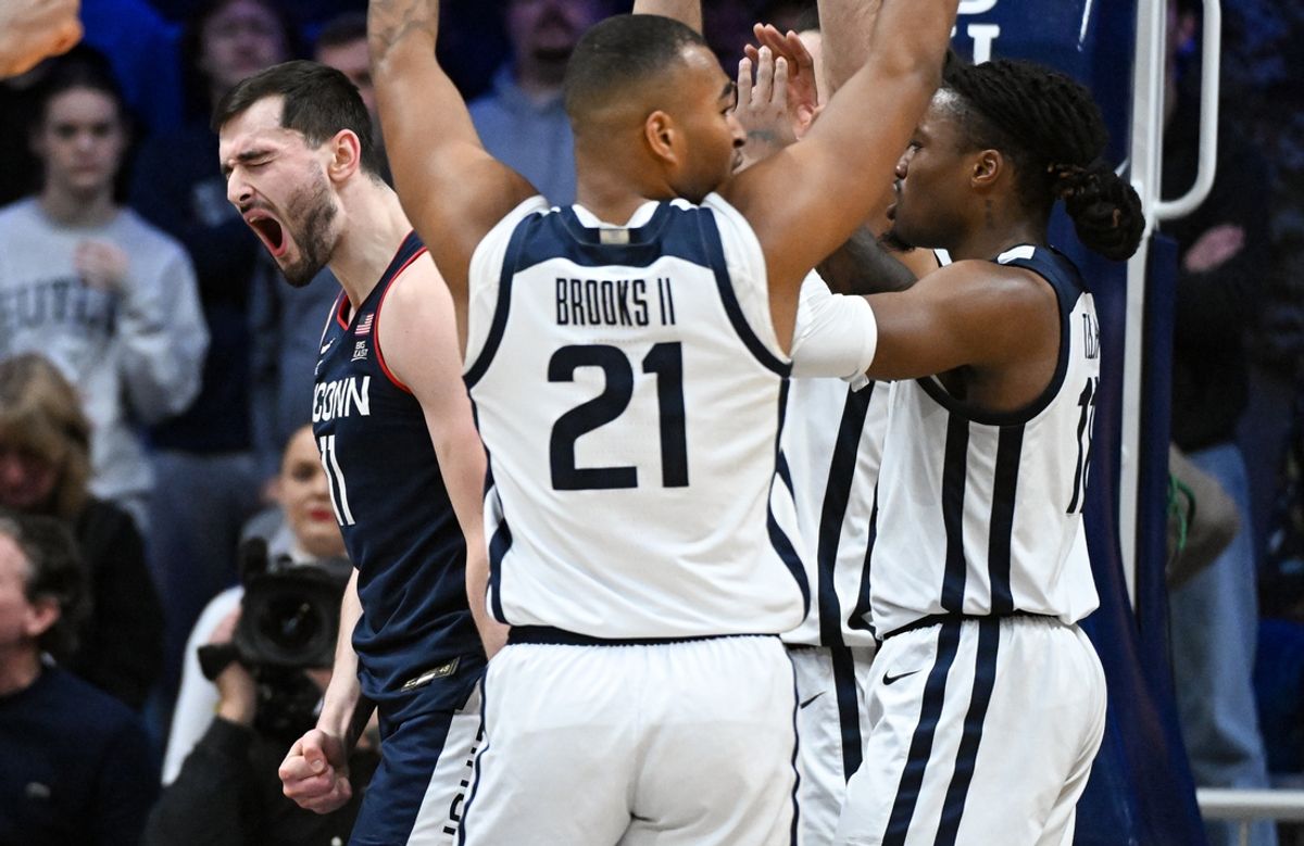 Dec 21, 2024; Indianapolis, Indiana, USA; Connecticut Huskies forward Alex Karaban (11) celebrates after a play during the first half against the Butler Bulldogs at Hinkle Fieldhouse. Mandatory Credit: Robert Goddin-Imagn Images