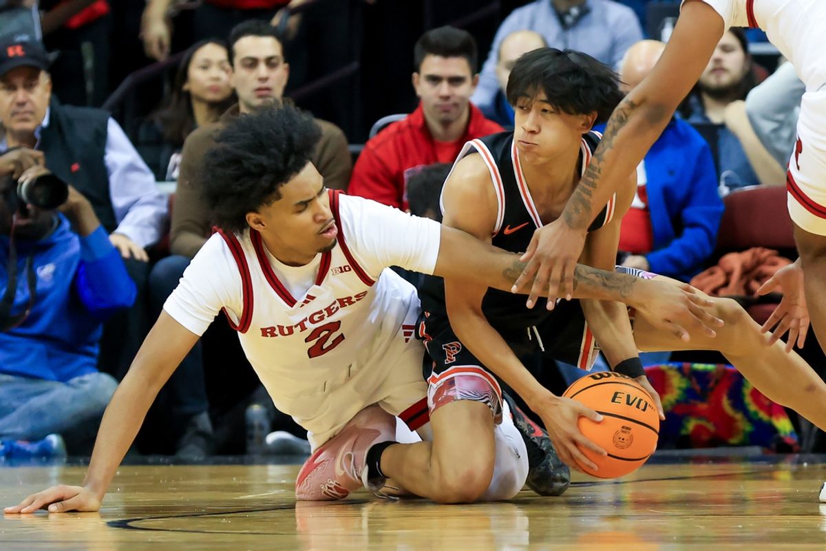 Dec 21, 2024; Newark, New Jersey, USA; Princeton Tigers guard Xaivian Lee (1) and Rutgers Scarlet Knights guard Dylan Harper (2) battle for the ball during the first half at Prudential Center. Mandatory Credit: Tom Horak-Imagn Images