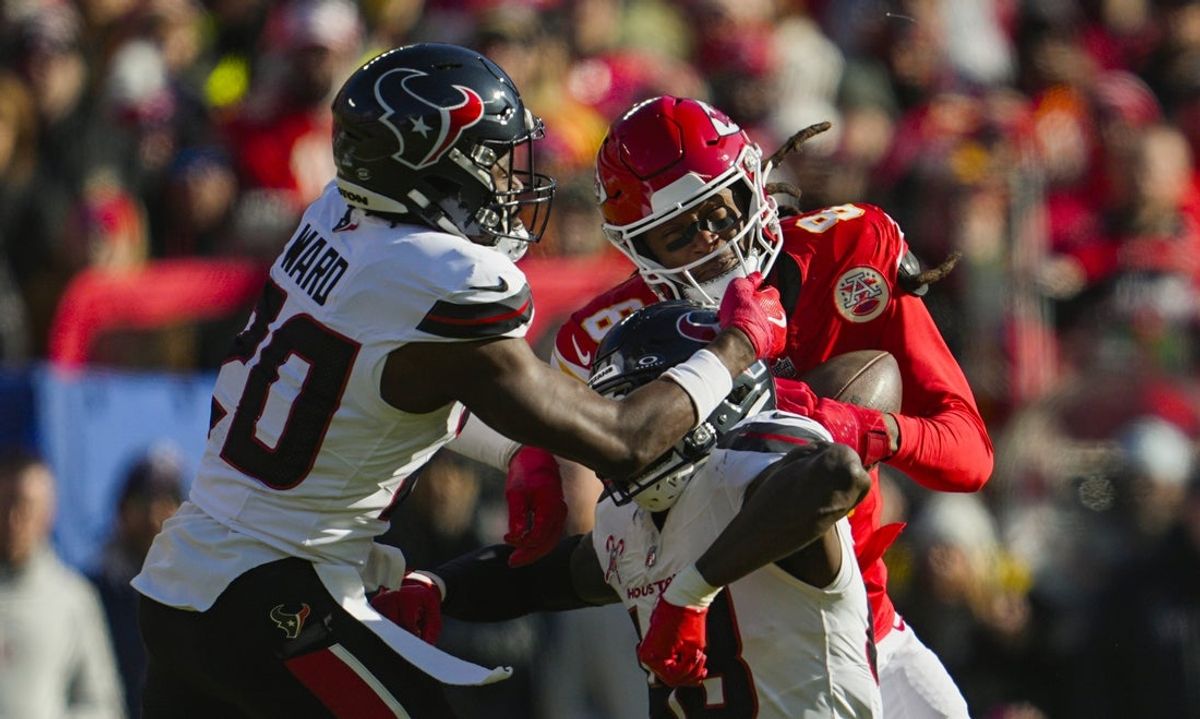 Dec 21, 2024; Kansas City, Missouri, USA; Kansas City Chiefs wide receiver DeAndre Hopkins (8) catches a pass against Houston Texans linebacker Christian Harris (48) and safety Jimmie Ward (20) during the first half at GEHA Field at Arrowhead Stadium. Mandatory Credit: Jay Biggerstaff-Imagn Images