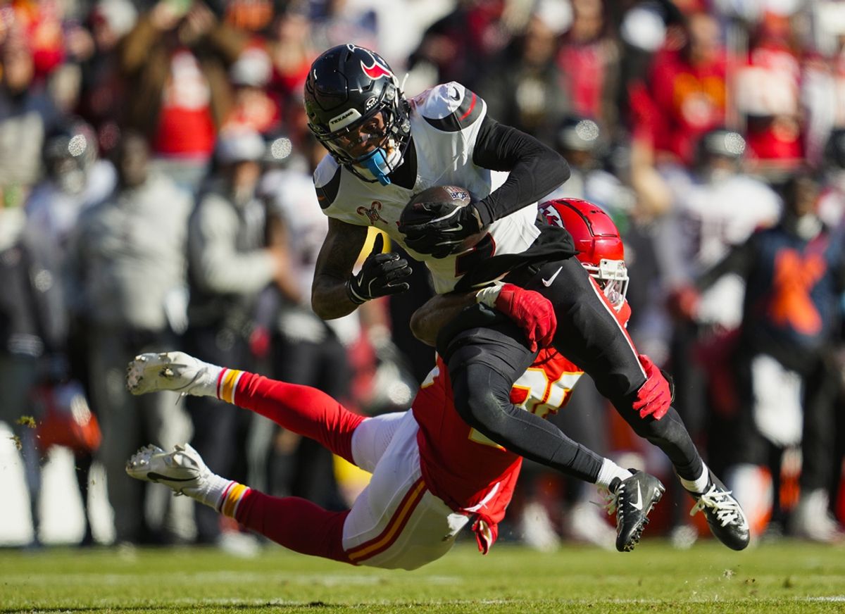Dec 21, 2024; Kansas City, Missouri, USA; Houston Texans wide receiver Tank Dell (3) is tackled by Kansas City Chiefs safety Justin Reid (20) during the first half at GEHA Field at Arrowhead Stadium. Mandatory Credit: Jay Biggerstaff-Imagn Images
