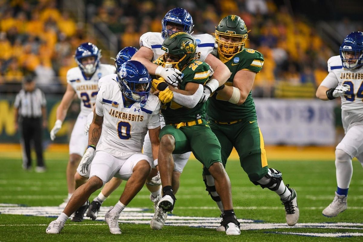 North Dakota State Bison running back CharMar Brown (25) gets tackled by South Dakota State defense on Saturday, Dec. 21, 2024, at Fargodome in Fargo, Nouth Dakota.