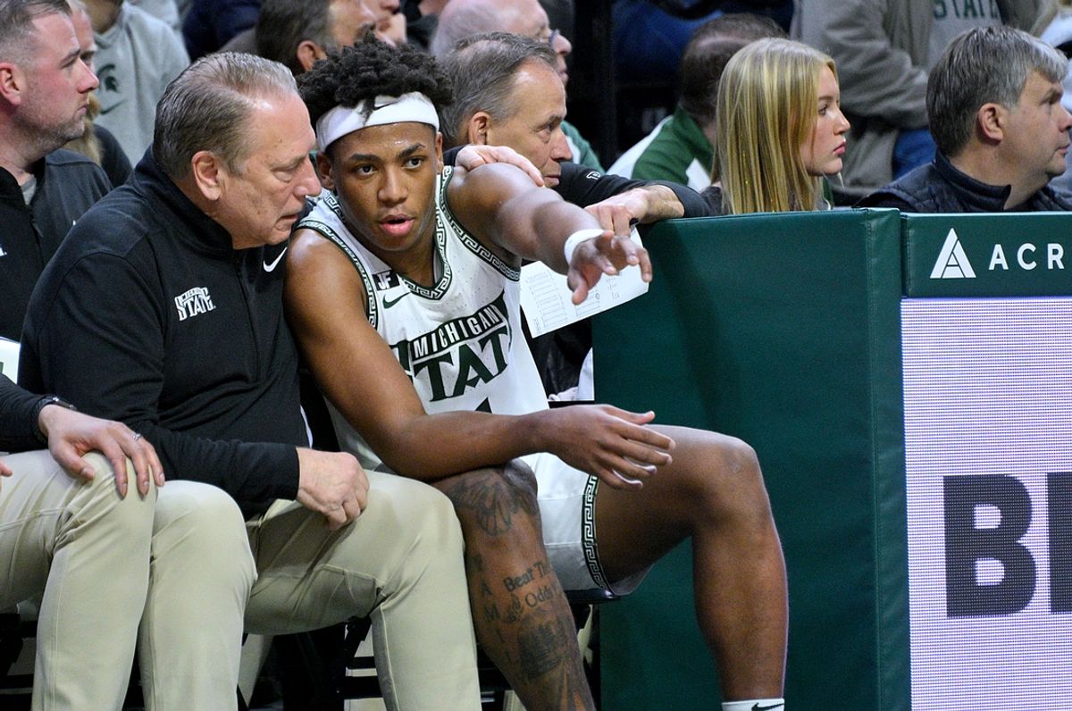 Dec 21, 2024; East Lansing, Michigan, USA;  Michigan State Spartans guard Jeremy Fears Jr. (1) talks over a play with Michigan State Spartans head coach Tom Izzo during the second half against the Florida Atlantic Owls at Jack Breslin Student Events Center. Mandatory Credit: Dale Young-Imagn Images