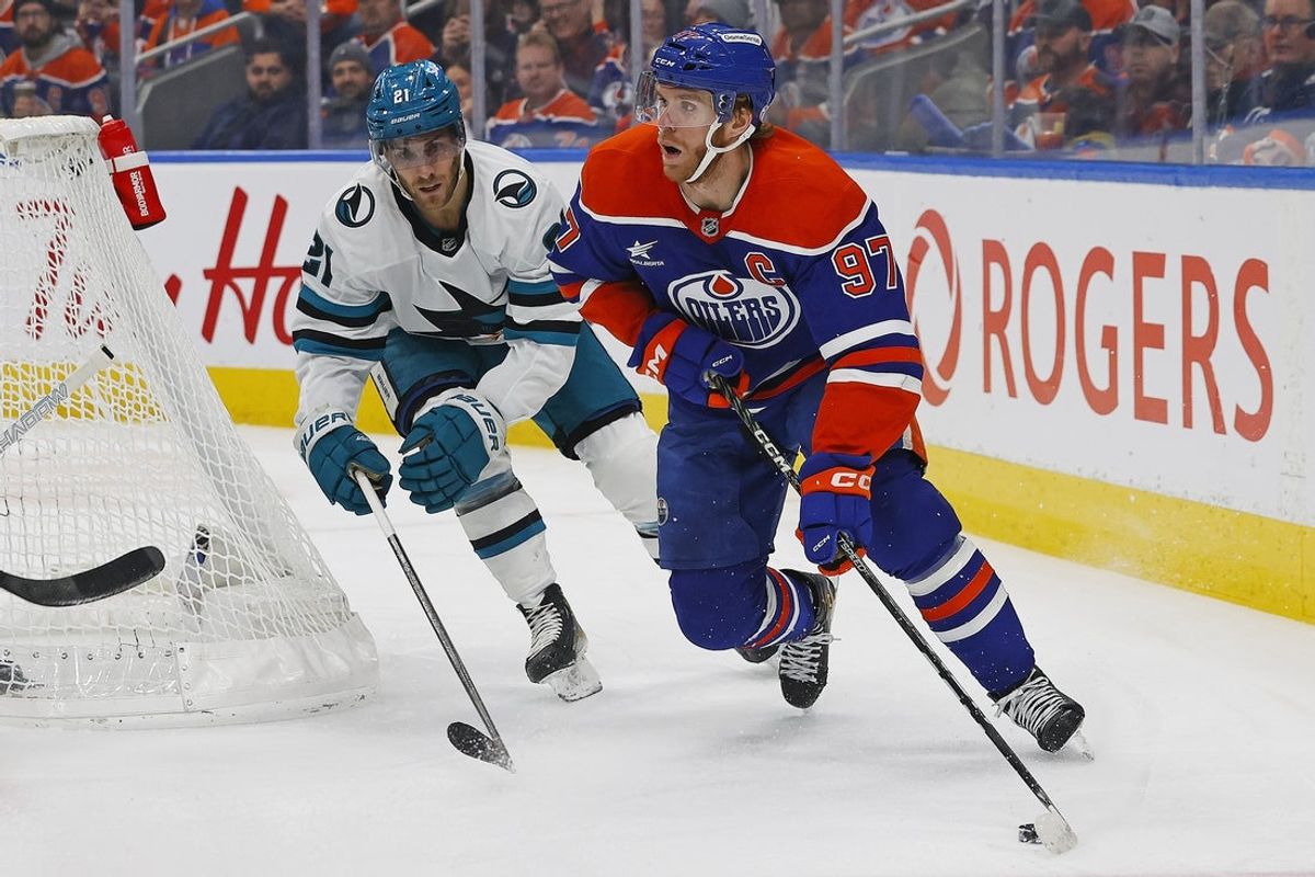 Dec 21, 2024; Edmonton, Alberta, CAN; Edmonton Oilers forward Connor McDavid (97) looks to make a pass in front of San Jose Sharks forward Alexander Wennberg (21) during the first period at Rogers Place. Mandatory Credit: Perry Nelson-Imagn Images