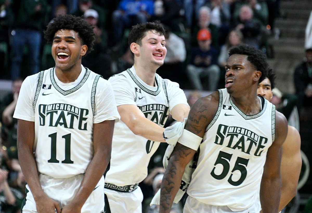 Dec 21, 2024; East Lansing, Michigan, USA;  Michigan State Spartans including guard Jase Richardson (11)  forward Frankie Fidler (8) and forward Coen Carr (55) celebrate a big play by Carr against the Florida Atlantic Owls during the second halfat Jack Breslin Student Events Center. Mandatory Credit: Dale Young-Imagn Images