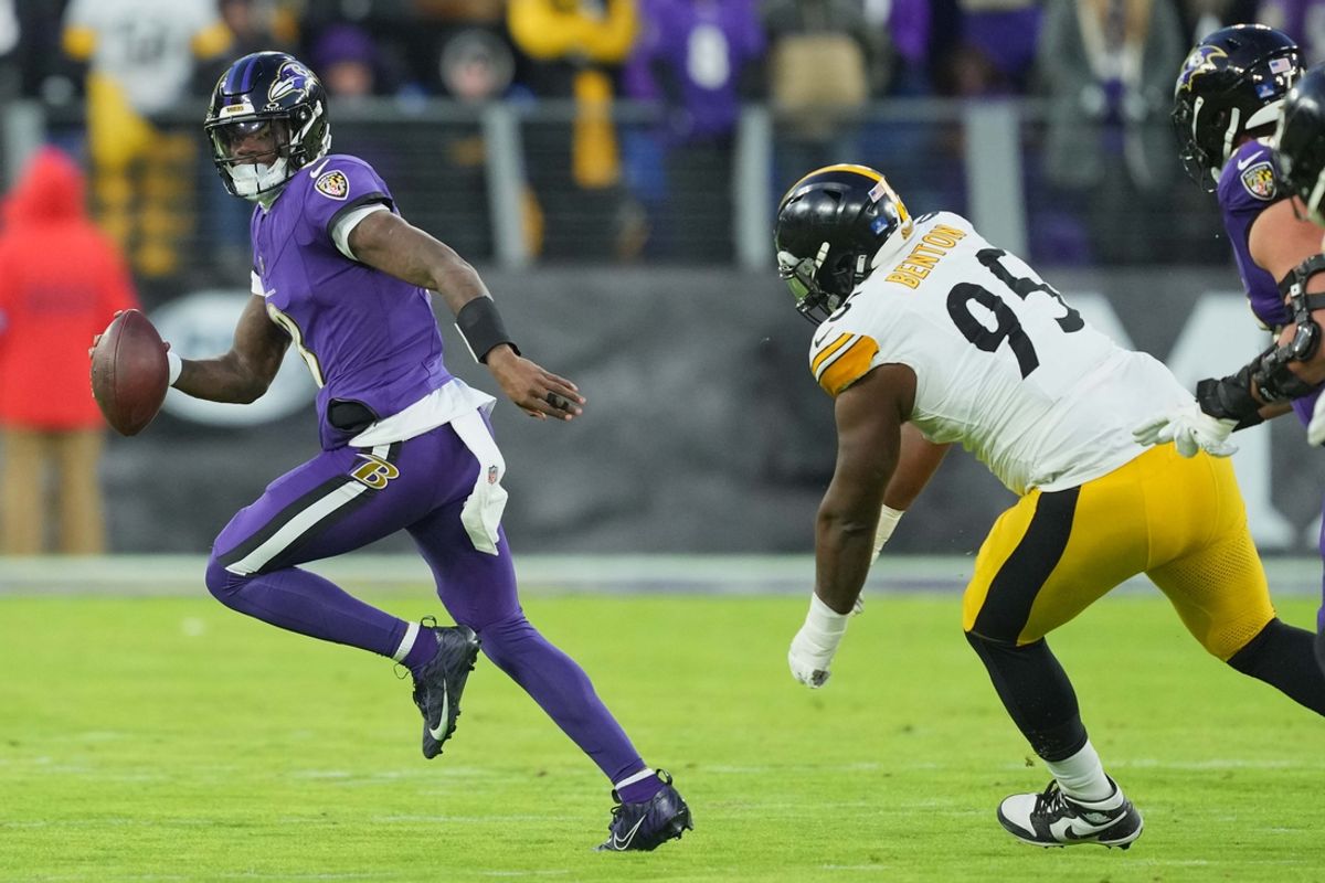 Dec 21, 2024; Baltimore, Maryland, USA; Baltimore Ravens quarterback Lamar Jackson (8) scrambles during the first quarter pressured by Pittsburgh Steelers tackle Keeanu Benton (95) at M&T Bank Stadium. Mandatory Credit: Mitch Stringer-Imagn Images