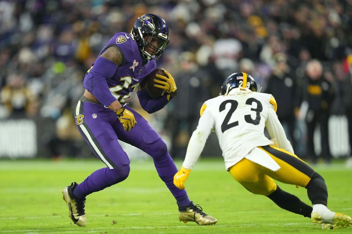 Dec 21, 2024; Baltimore, Maryland, USA; Baltimore Ravens running back Derrick Henry (22) is defended by Pittsburgh Steelers safety Damontae Kazee (23) in the first quarter at M&T Bank Stadium. Mandatory Credit: Mitch Stringer-Imagn Images