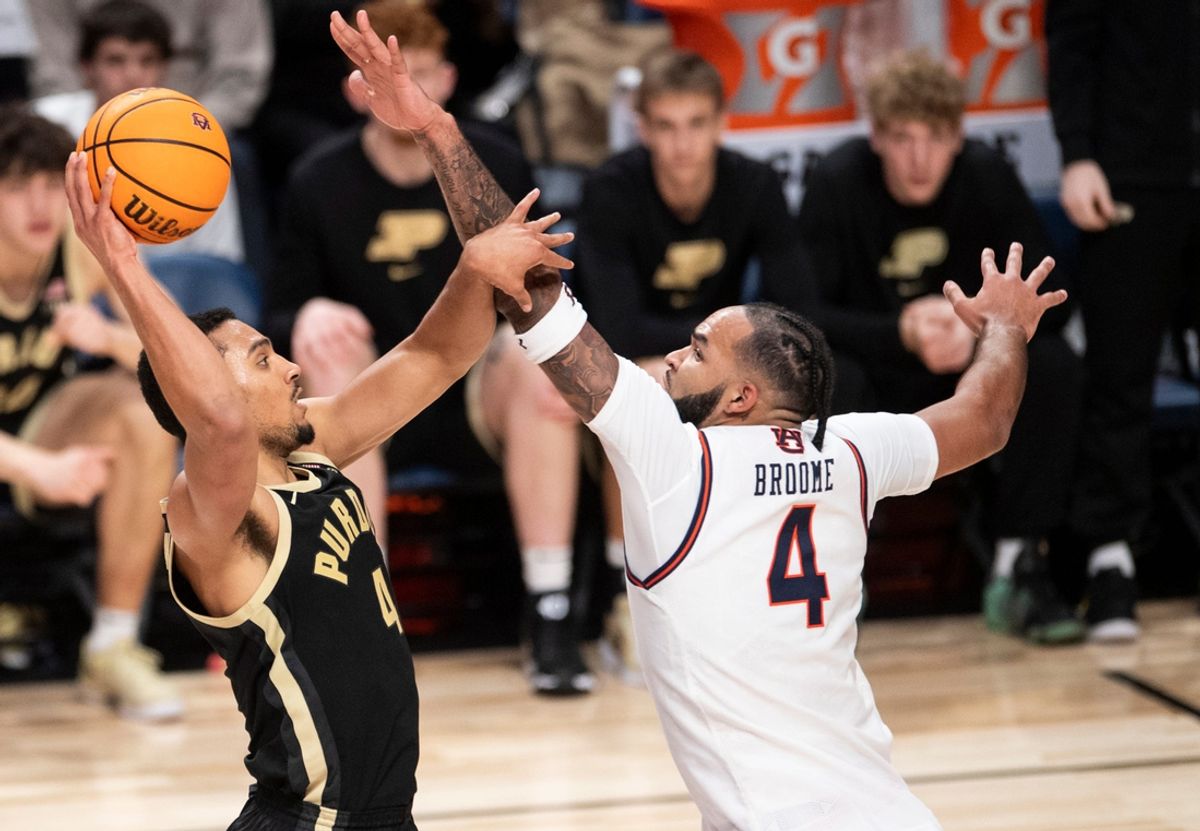 Purdue Boilermakers forward Trey Kaufman-Renn (4) goes up for a layup over Auburn Tigers forward Johni Broome (4) as Auburn Tigers take on Purdue Boilermakers at Legacy Arena in Birmingham, Ala., on Saturday, Dec. 21, 2024. Auburn Tigers defeated Purdue Boilermakers 87-69.