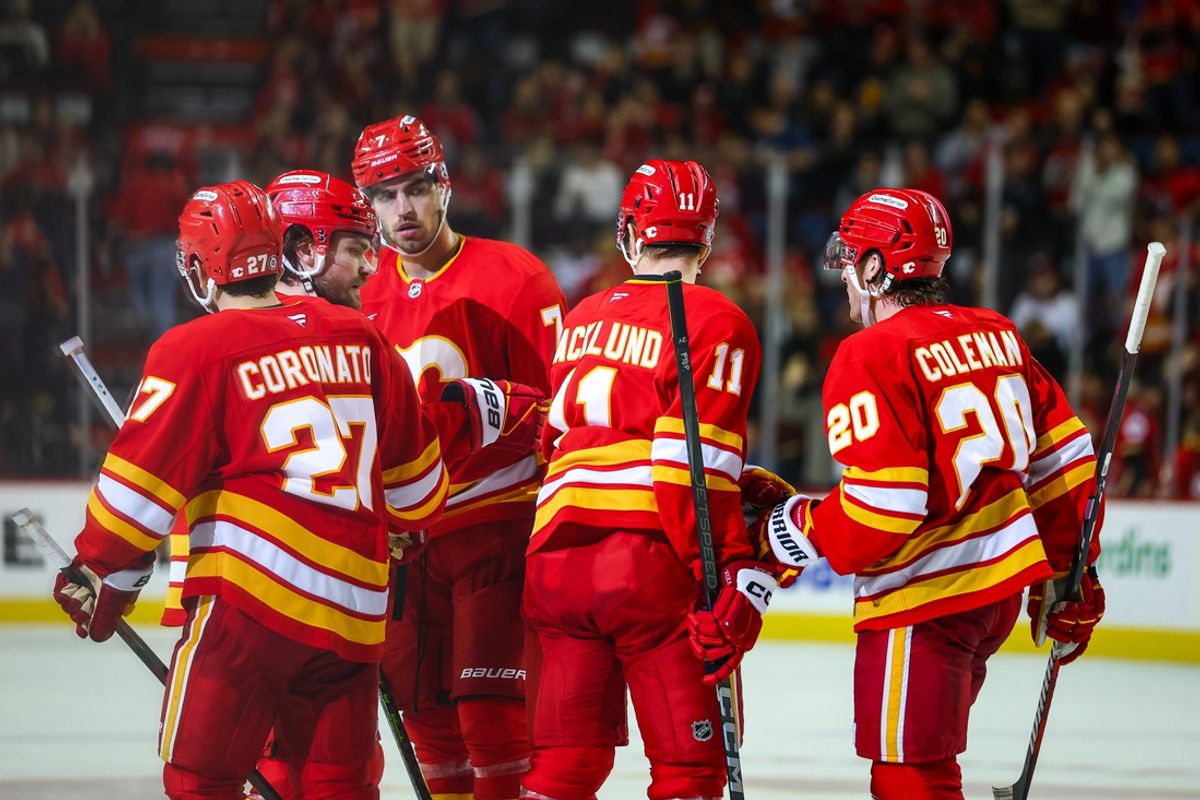 Dec 21, 2024; Calgary, Alberta, CAN; Calgary Flames center Mikael Backlund (11) celebrates his goal with teammates against the Chicago Blackhawks during the third period at Scotiabank Saddledome. Mandatory Credit: Sergei Belski-Imagn Images