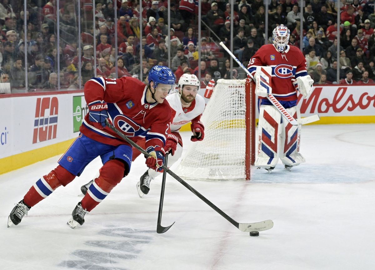 Dec 21, 2024; Montreal, Quebec, CAN; Montreal Canadiens defenseman Kaiden Guhle (21) plays the puck and Detroit Red Wings forward Michael Rasmussen (27) forechecks during the first period at the Bell Centre. Mandatory Credit: Eric Bolte-Imagn Images
