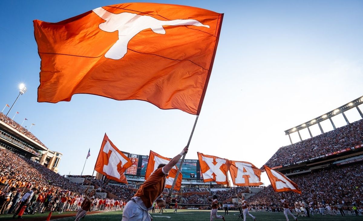 Dec 21, 2024; Austin, Texas, USA; The cheer team celebrate Texas touchdown in the second quarter as the Texas Longhorns play the Clemson Tigers in the first round of the College Football Playoffs at Texas Memorial Stadium. Mandatory Credit: Sara Diggins/USA Today Network via Imagn Images