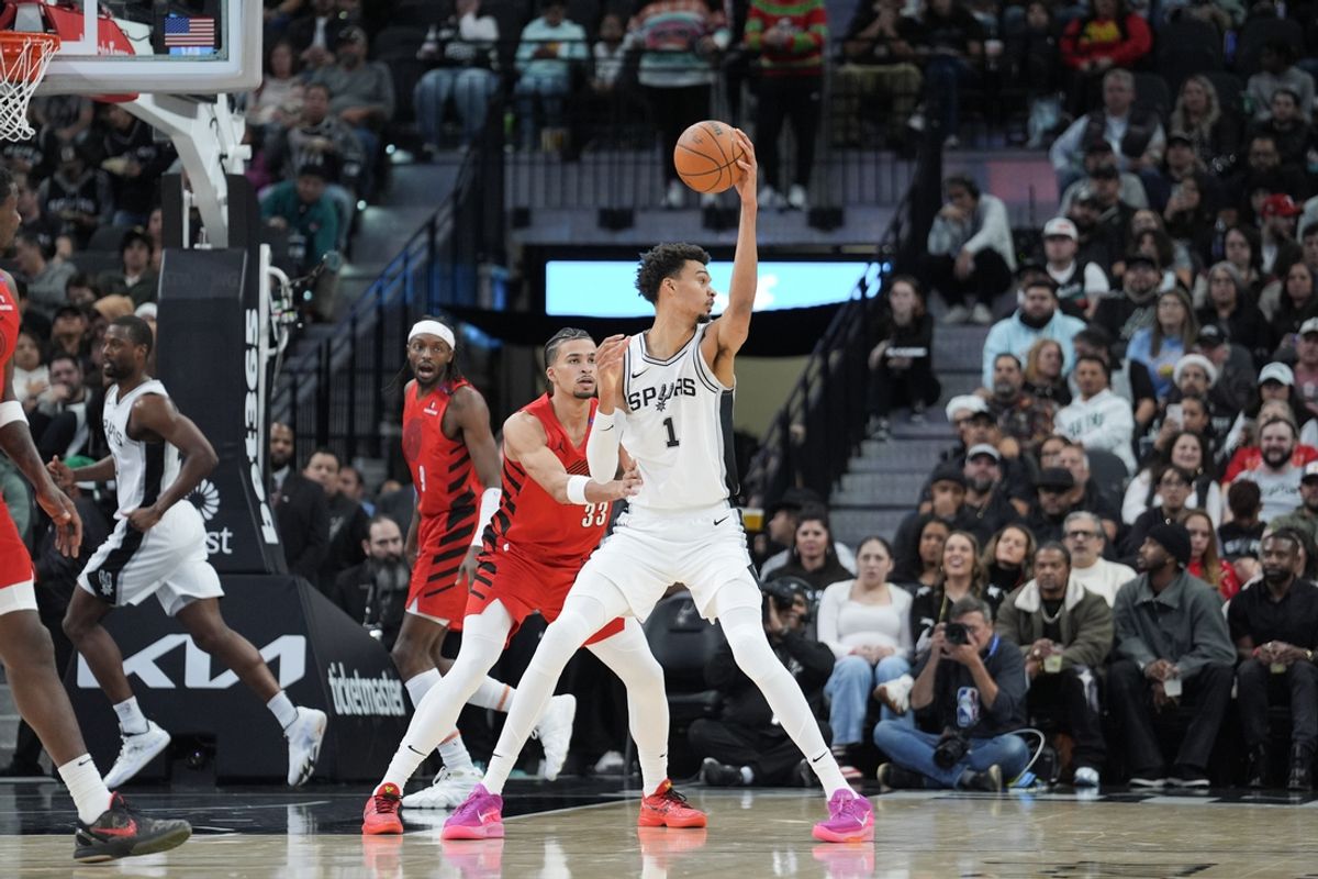 Dec 21, 2024; San Antonio, Texas, USA;  San Antonio Spurs center Victor Wembanyama (1) controls the ball against Portland Trail Blazers forward Toumani Camara (33) in the first half at Frost Bank Center. Mandatory Credit: Daniel Dunn-Imagn Images