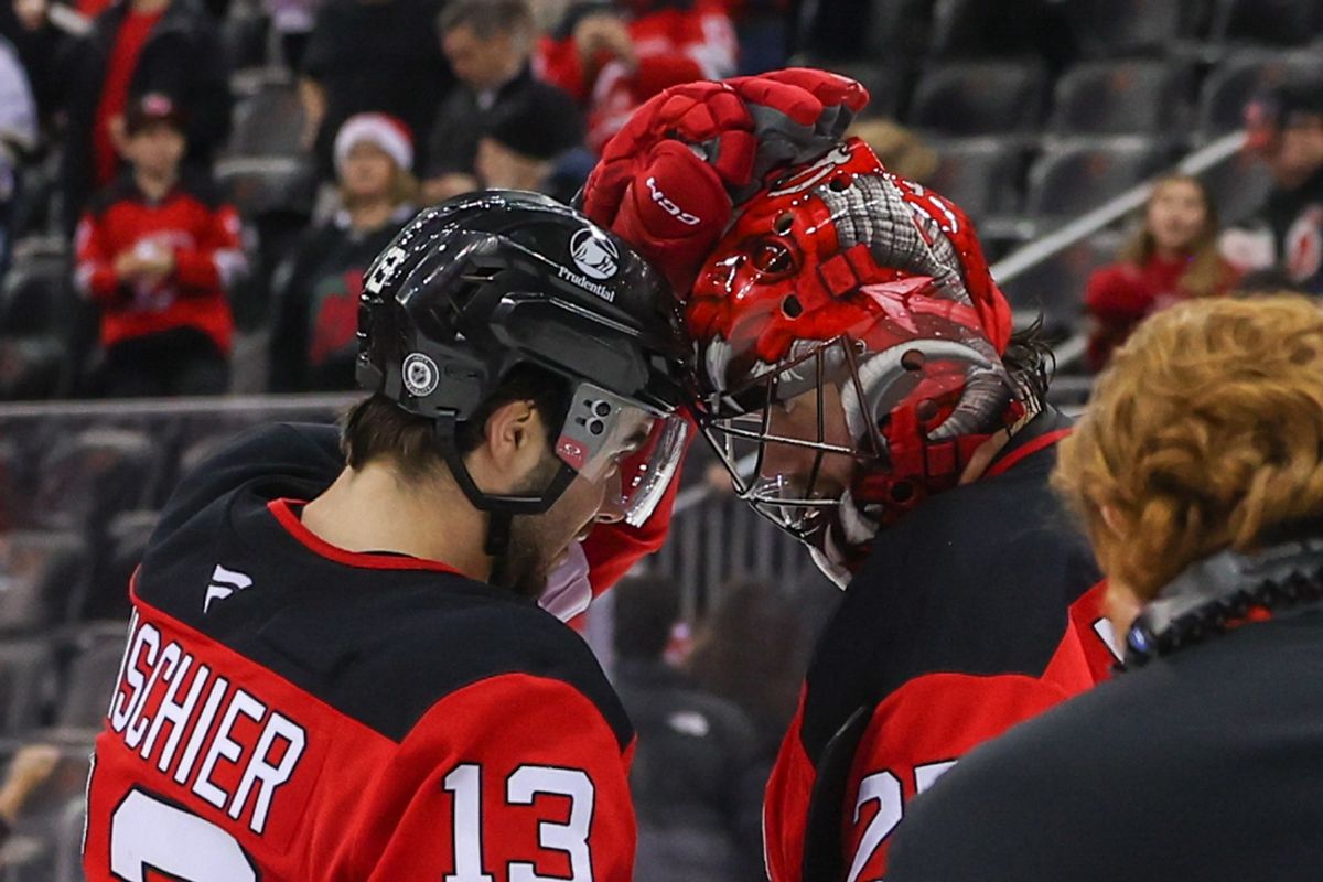 Dec 21, 2024; Newark, New Jersey, USA; New Jersey Devils center Nico Hischier (13) and goaltender Jacob Markstrom (25) celebrate their win over the Pittsburgh Penguins at Prudential Center. Mandatory Credit: Ed Mulholland-Imagn Images