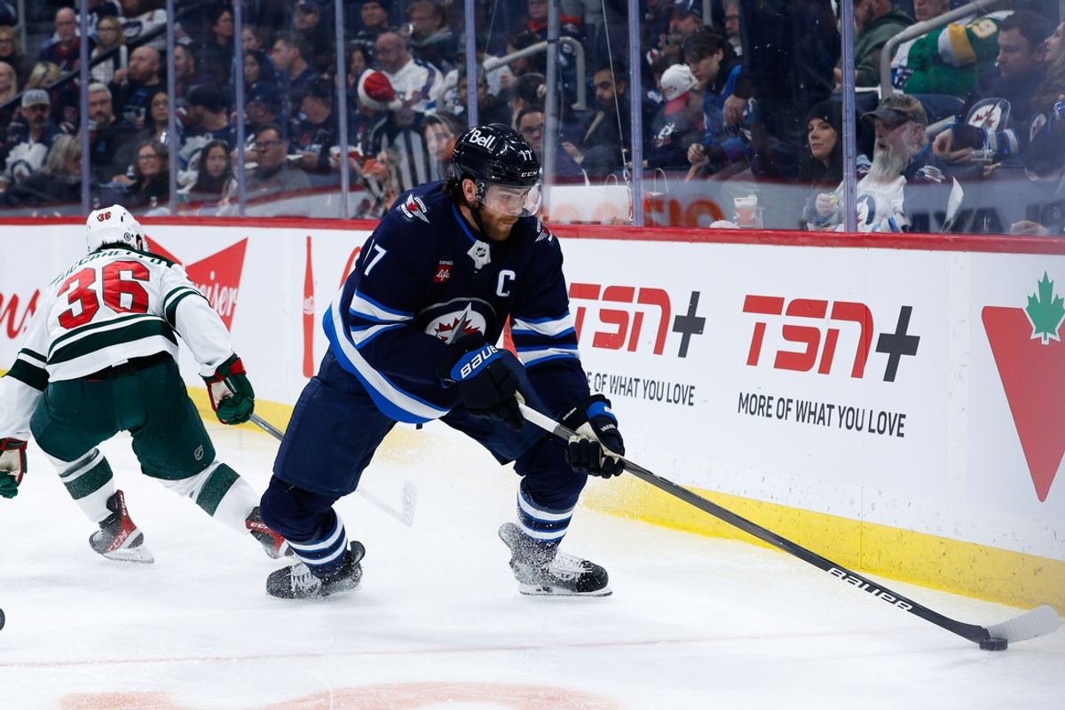 Dec 21, 2024; Winnipeg, Manitoba, CAN;  Winnipeg Jets forward Adam Lowry (17) turns away from Minnesota Wild forward Ryan Hartman (38) during the second period at Canada Life Centre. Mandatory Credit: Terrence Lee-Imagn Images
