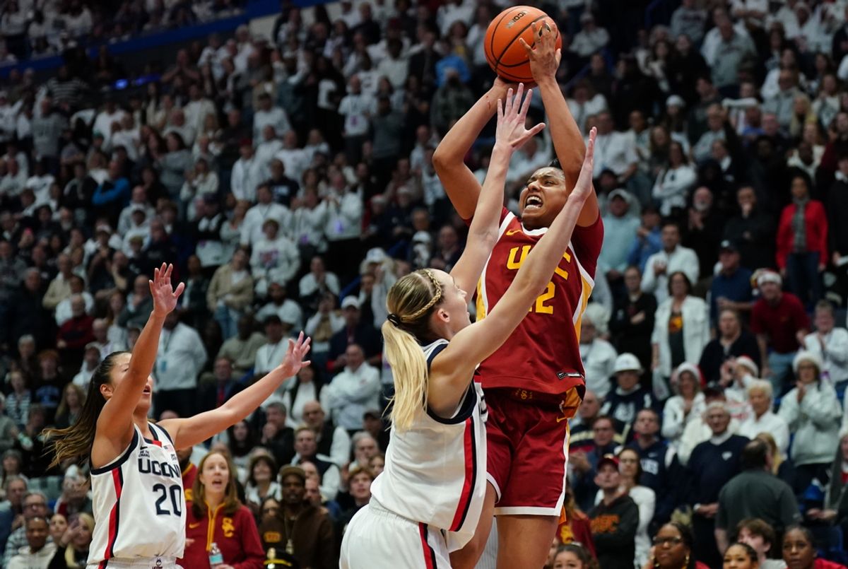 Dec 21, 2024; Hartford, Connecticut, USA; USC Trojans guard JuJu Watkins (12) shoots against UConn Huskies guard Paige Bueckers (5) in the second half at XL Center. Mandatory Credit: David Butler II-Imagn Images